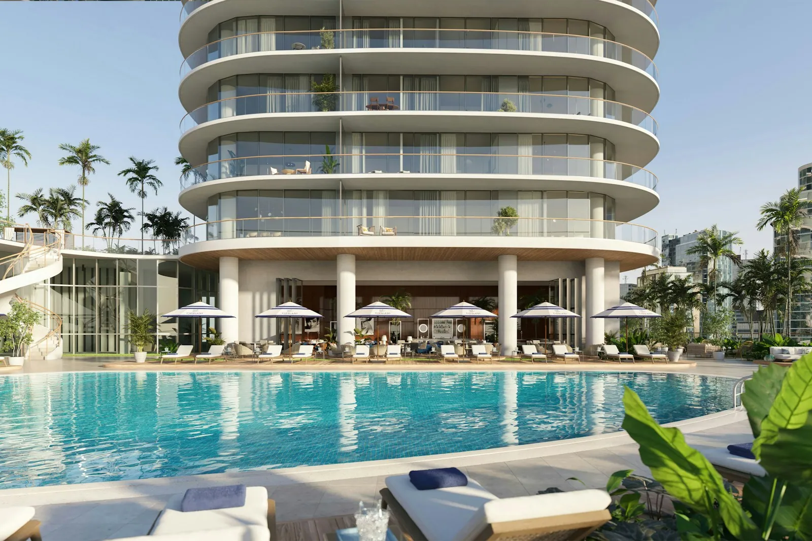 Resort pool deck with cabanas and palm trees at Cipriani Residences Miami